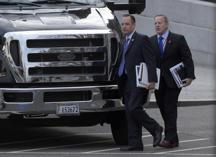 Donald Trump's chief of staff Reince Priebus and incoming press secretary Sean Spicer walk to their bus after a meeting at the Eisenhower Executive Office Building on Friday. (Susan Walsh/AP)</p>  