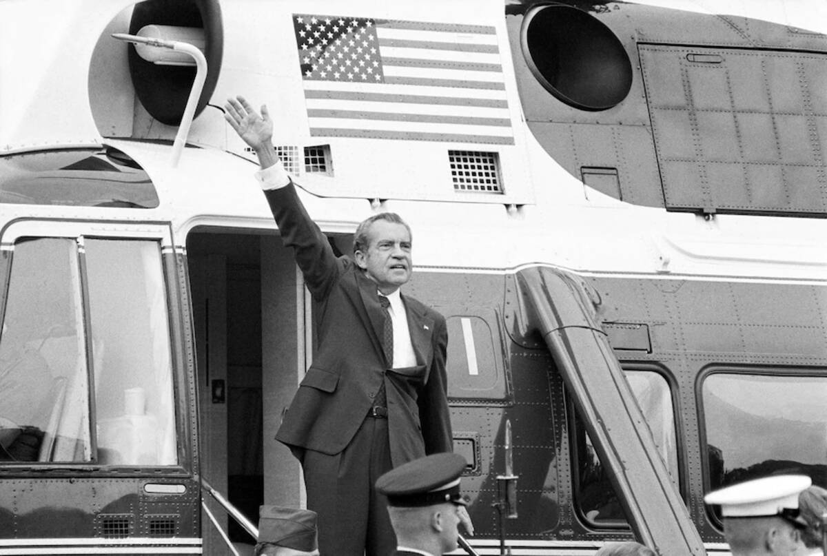 Richard M. Nixon waves goodbye while departing the White House in 1974. (Chick Harrity/AP)