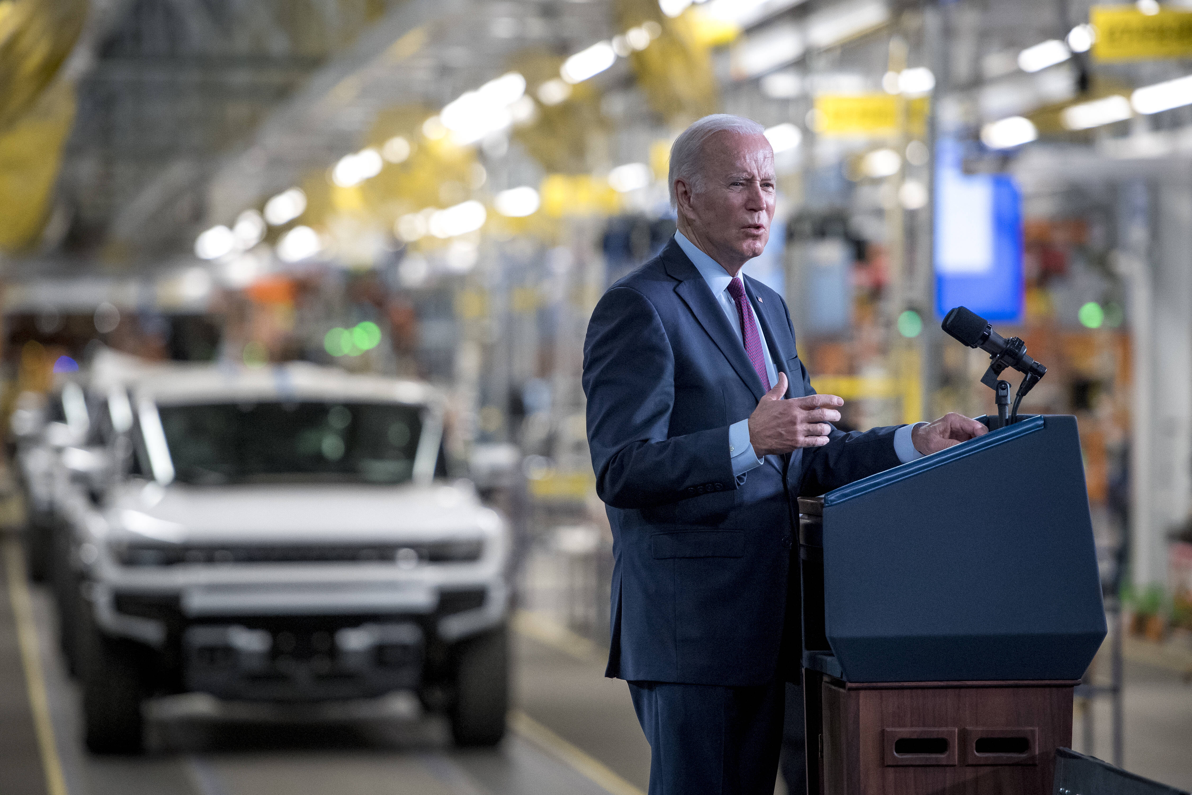 Biden stands in front of an electric Humvee at the General Motors Factory in Detroit. (Nic Antaya/Getty Images)