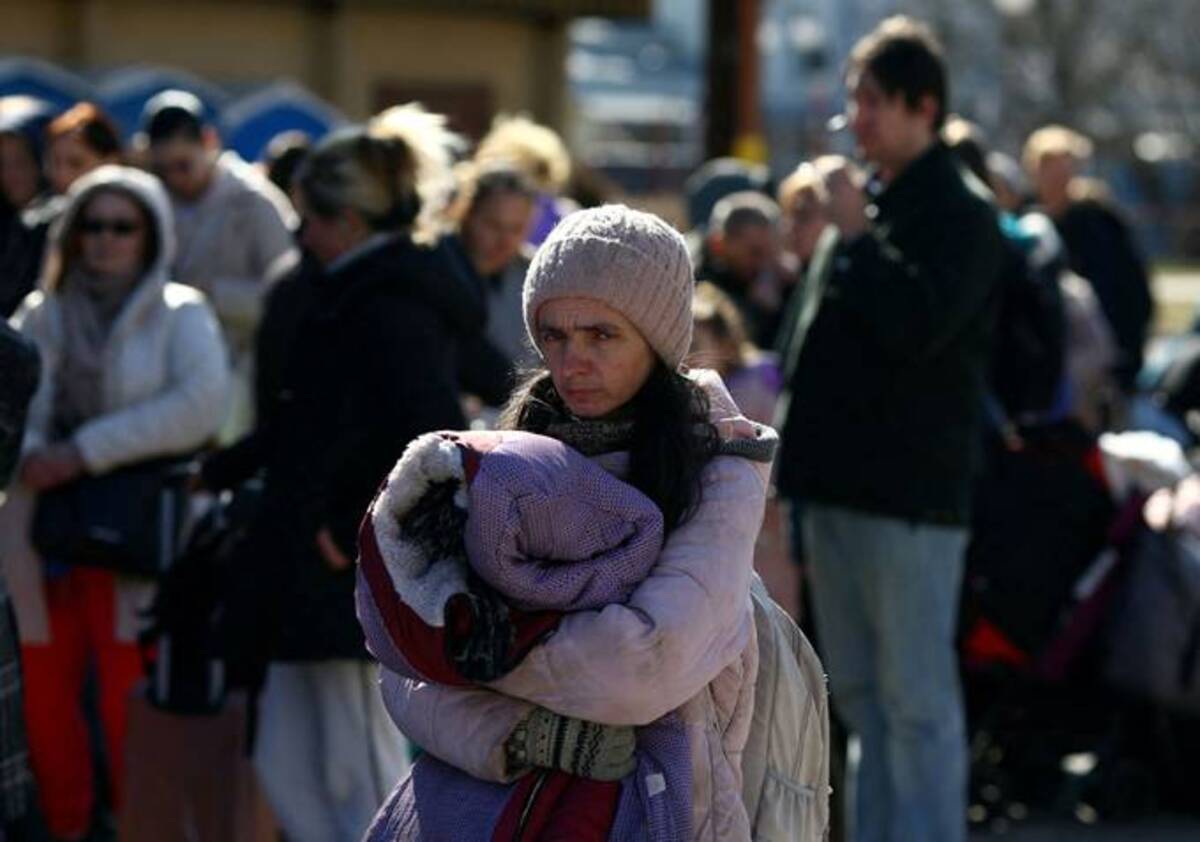 Ukrainian refugees wait to board a train back to the Ukraine on Thursday outside of Przemysl Glowny train station in Poland after fleeing the Russian invasion. (REUTERS/Hannah McKay)