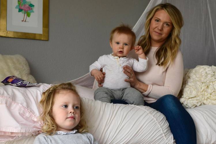 Tara Thomas and her daughter Avery, 3, sit in Avery's bedroom along with 10-month-old Nixon in their home in Novato, Calif. Thomas had a Nest camera in Avery's bedroom that was hacked last August. (Deanne Fitzmaurice for The Washington Post)  