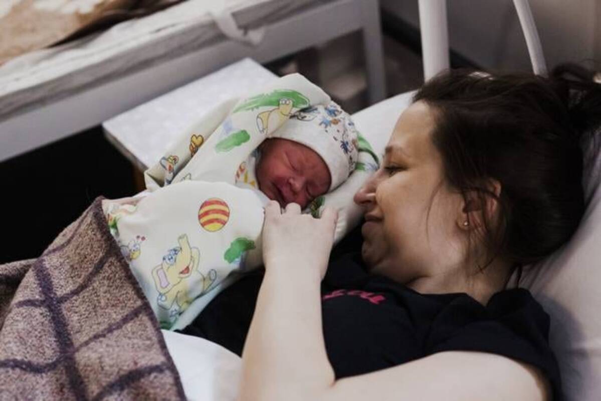 A woman holds her newborn in the bomb shelter of a maternity hospital on March 30 near Kyiv, Ukraine. (Anastasia Vlasova/Getty Images)