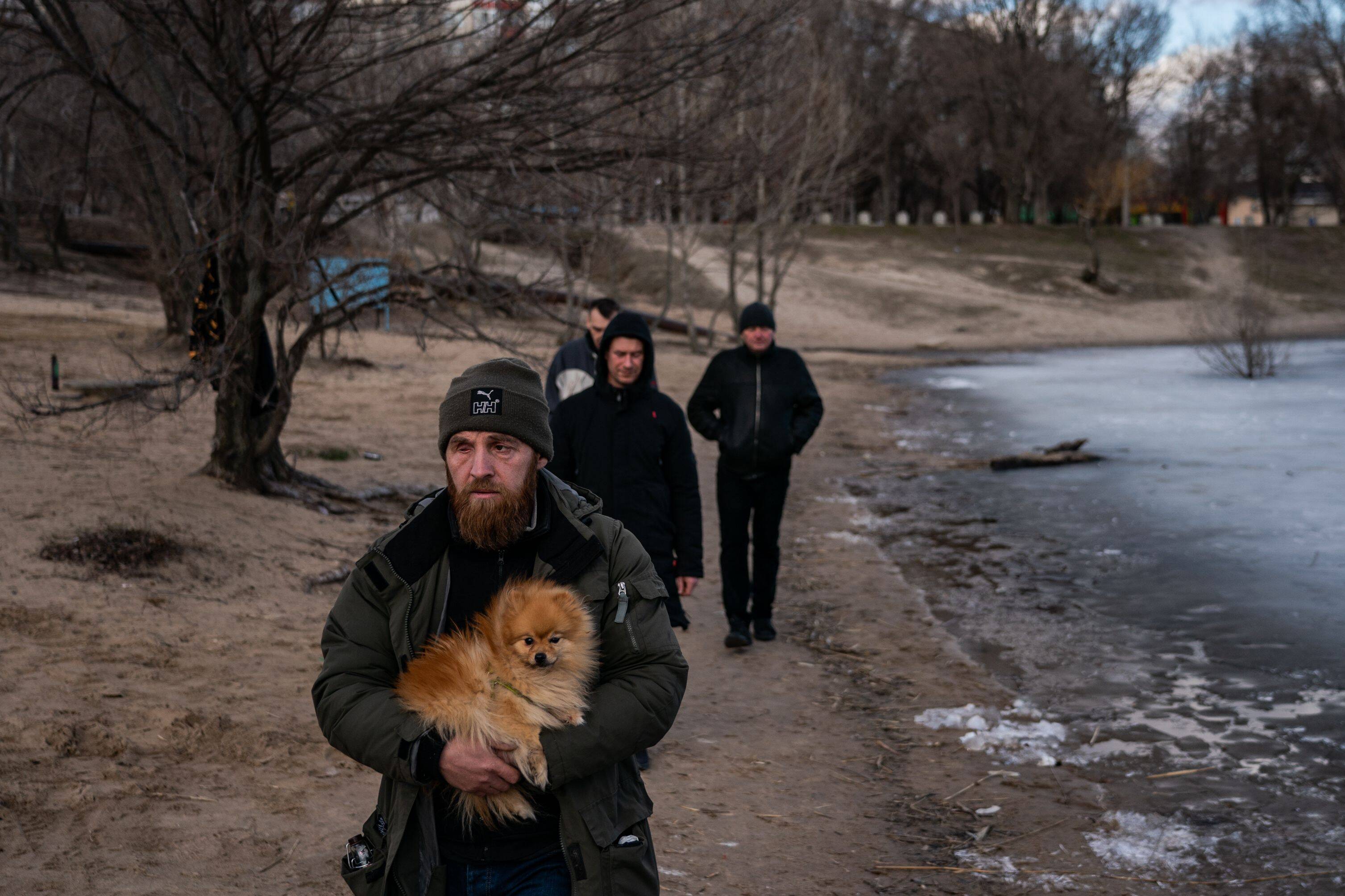 People walk along the Chyste lake in Severodonetsk, Luhansk Oblast, Ukraine on Feb. 20. (Salwan Georges/The Washington Post)