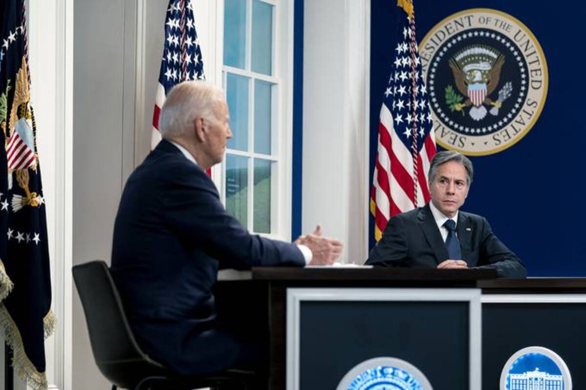 Antony Blinken, secretary of state, listens as President Biden, right, speaks during a virtual discussion about climate change with world leaders. (Stefani Reynolds/Bloomberg News)