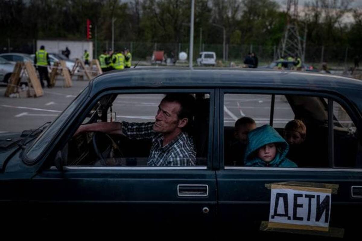 A family from Mariupol are seen after registering at a reception center for internally displaced persons on Monday in Zaporizhzhia, Ukraine. (Nicole Tung/For The Washington Post)