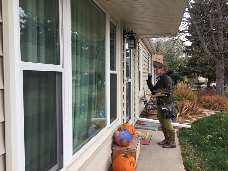 Lynn Young, a Clinton volunteer, canvasses in the suburbs of Colorado Springs yesterday. (David Weigel/The Washington Post)</p>  