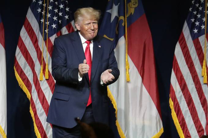 Former president Donald Trump acknowledges the crowd after he spoke at a state Republican meeting in North Carolina, where he rehashed unfounded arguments about 2020 election fraud. (Chris Seward/AP)