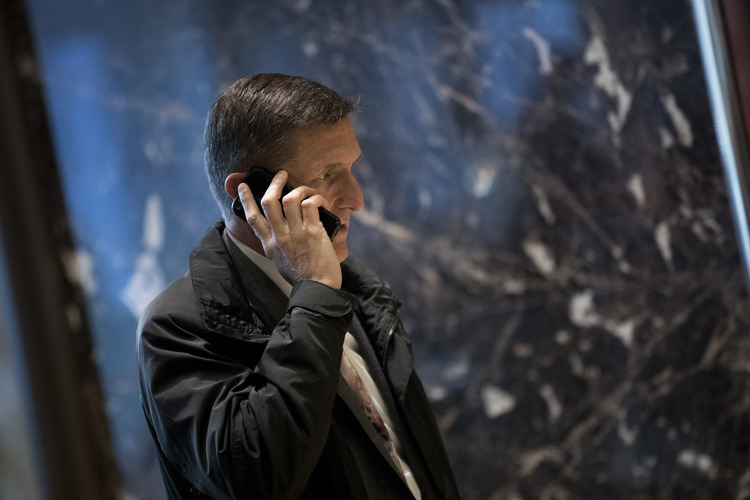 Michael Flynn talks on his phone in Trump Tower. Perhaps with someone in Russia. (Drew Angerer/Getty Images)</p>  