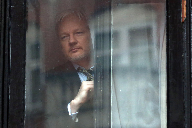 Julian Assange is hiding out in the Ecuadorian embassy of London to avoid facing prosecution. (Carl Court/Getty Images)</p>