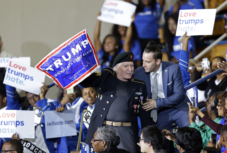 A Trump supporter is removed during Obama's speech at Fayetteville State. (Gerry Broome/AP)</p>  