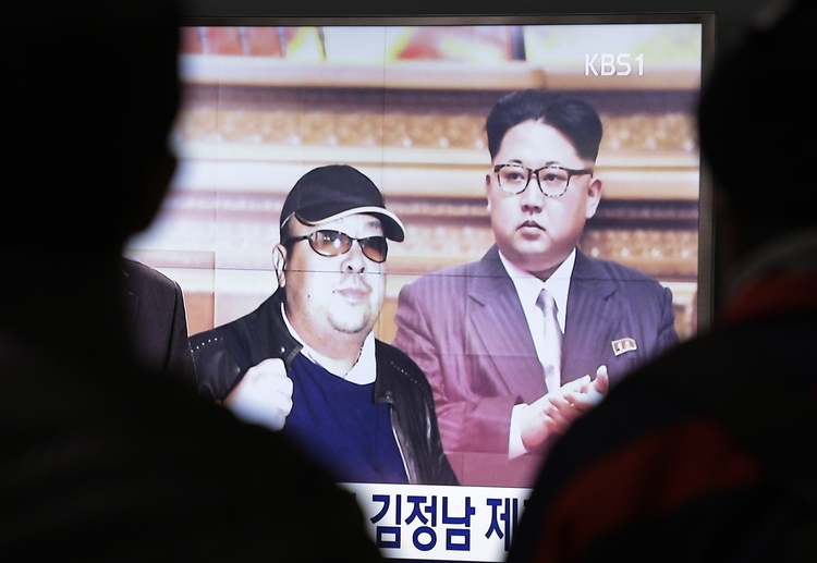 A TV screen displays pictures of&nbsp;Kim Jong Un and&nbsp;Kim Jong Nam. (Ahn Young-joon/AP)</p>  