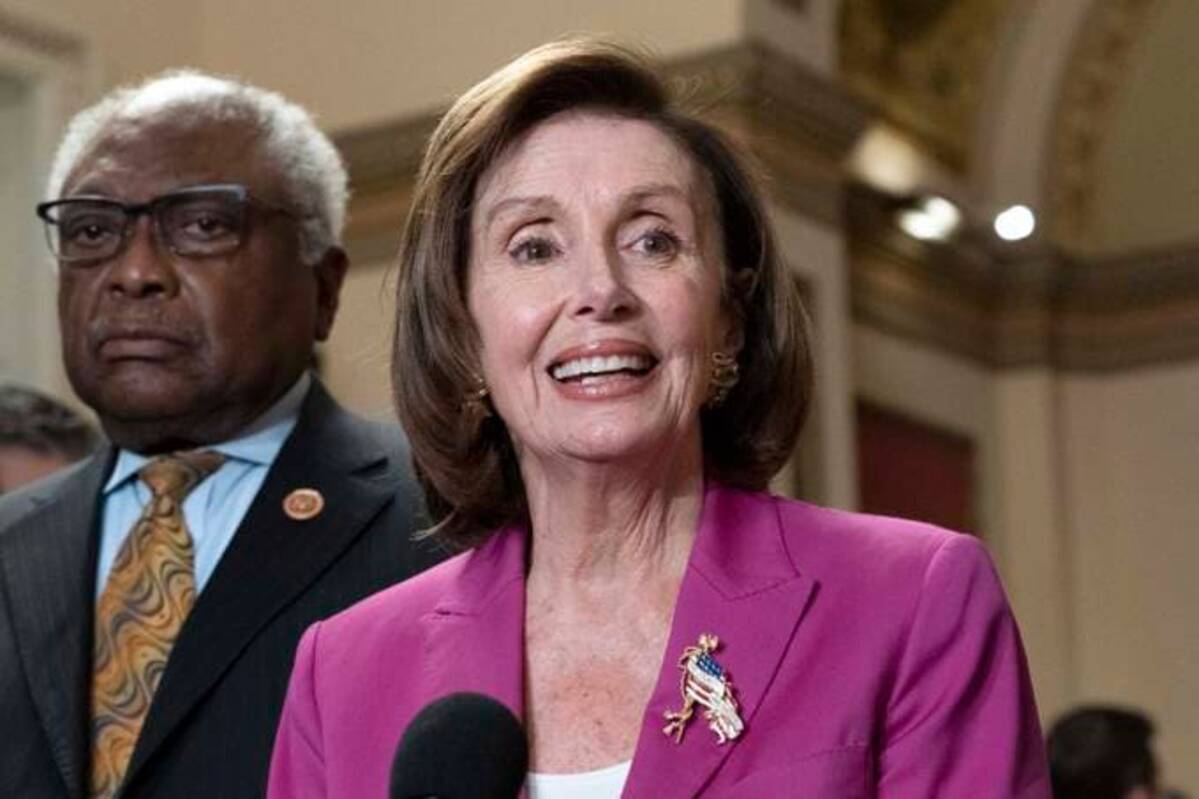 House Speaker Nancy Pelosi (D-Calif.), accompanied by House Majority Whip James E. Clyburn (D-S.C.), speaks to reporters at the Capitol. (Jose Luis Magana/AP)