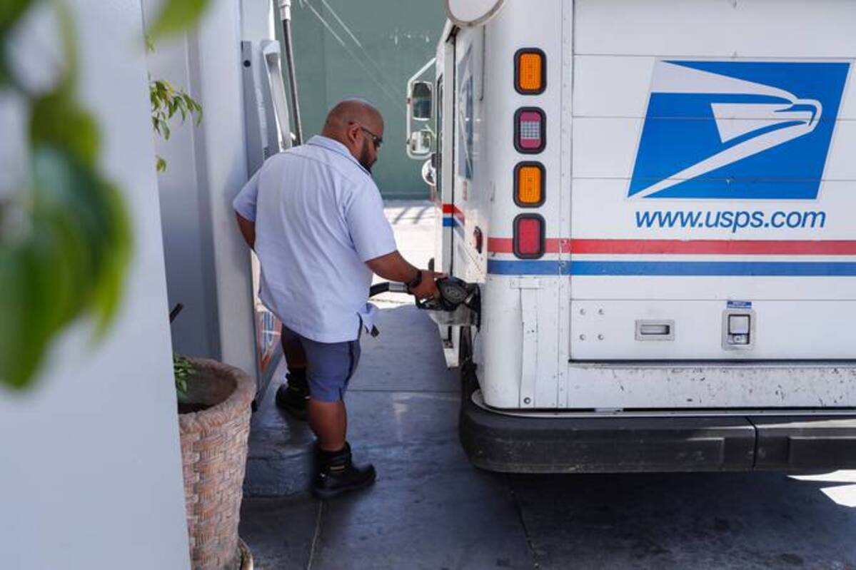 &nbsp;A postal worker fills up at a gas station in Los Angeles. (Caroline Brehman/EPA-EFE/Shutterstock)&nbsp;