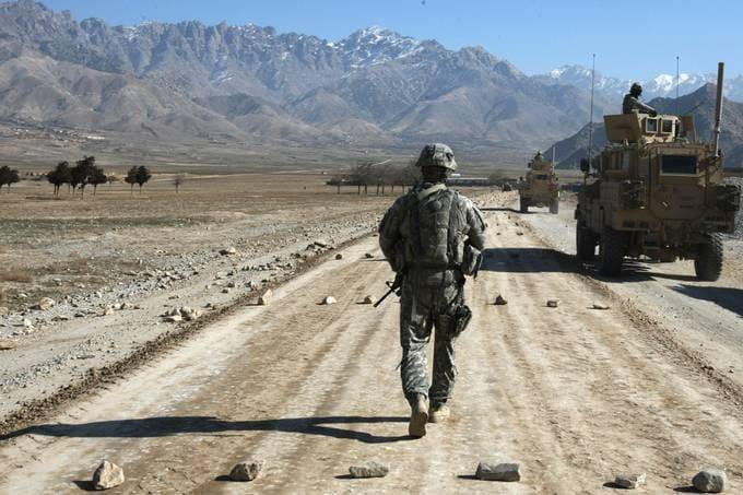A U.S. soldier walks along a road that is under construction near Bagram, about 37 miles from Kabul, in 2010. (Joël Saget/AFP/Getty Images)