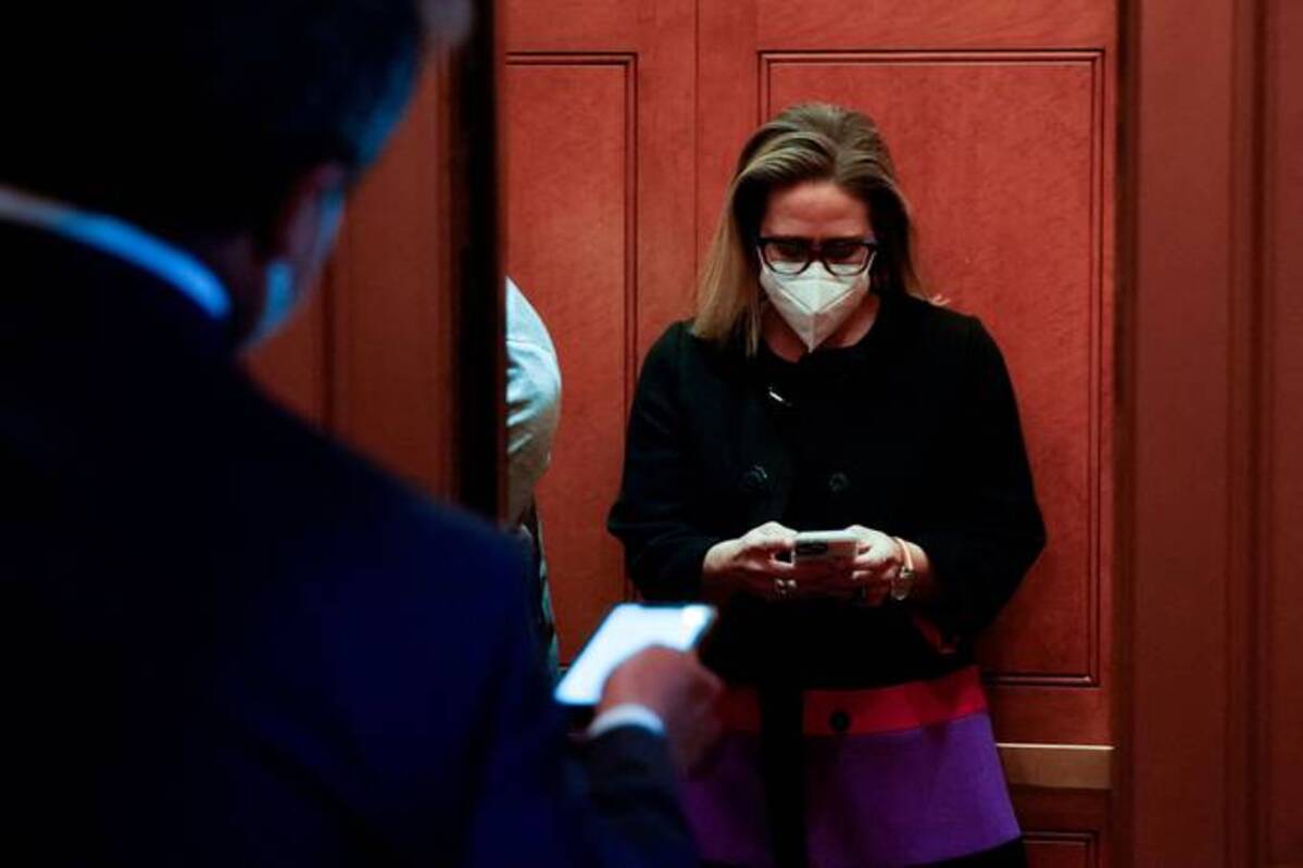 Sen. Kyrsten Sinema (D-Ariz.) boards an elevator during a vote at the U.S. Capitol on Jan. 13. (Elizabeth Frantz/Reuters)