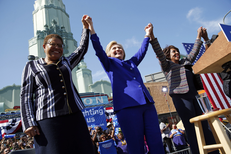 Hillary Clinton&nbsp;celebrates at a rally with Democratic Reps.&nbsp;Karen Bass&nbsp;and Maxine Waters yesterday&nbsp;in Los Angeles. (AP Photo/John Locher)</p>  