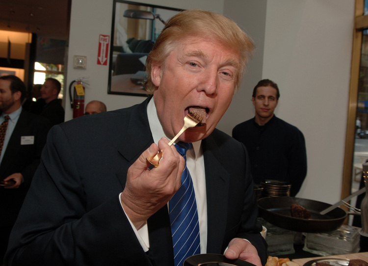 Trump eats a bite of a Trump Steak during a launch party at The Sharper Image years ago. (Photo by Stephen Lovekin/WireImage for Hill &amp; Knowlton)</p>  