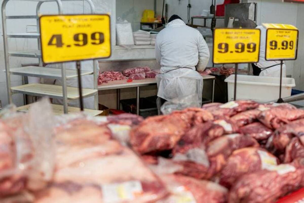 A grocery store worker wears a mask while working in the meat department of a grocery store. (Lucas Jackson/Reuters)