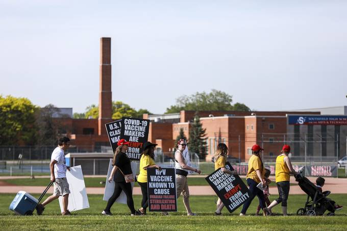 People protest vaccines outside Southfield High School in Southfield, Mich. (Kimberly P. Mitchell/Detroit Free Press/AP)