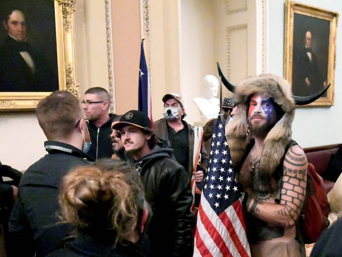 Jacob Anthony Chansley of Arizona stands with other supporters of former president Donald Trump on the second floor of the U.S. Capitol after breaching security defenses on Jan. 6 (REUTERS/Mike Theiler/File Photo)