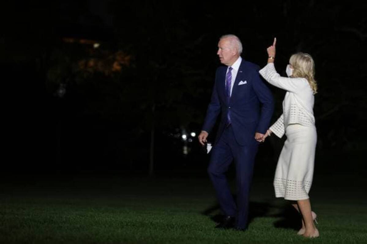 Biden and first lady Jill Biden stop to look at the moon as they arrive on the South Lawn of the White House from a trip to Baltimore. (Oliver Contreras/Pool/EPA-EFE/Shutterstock)