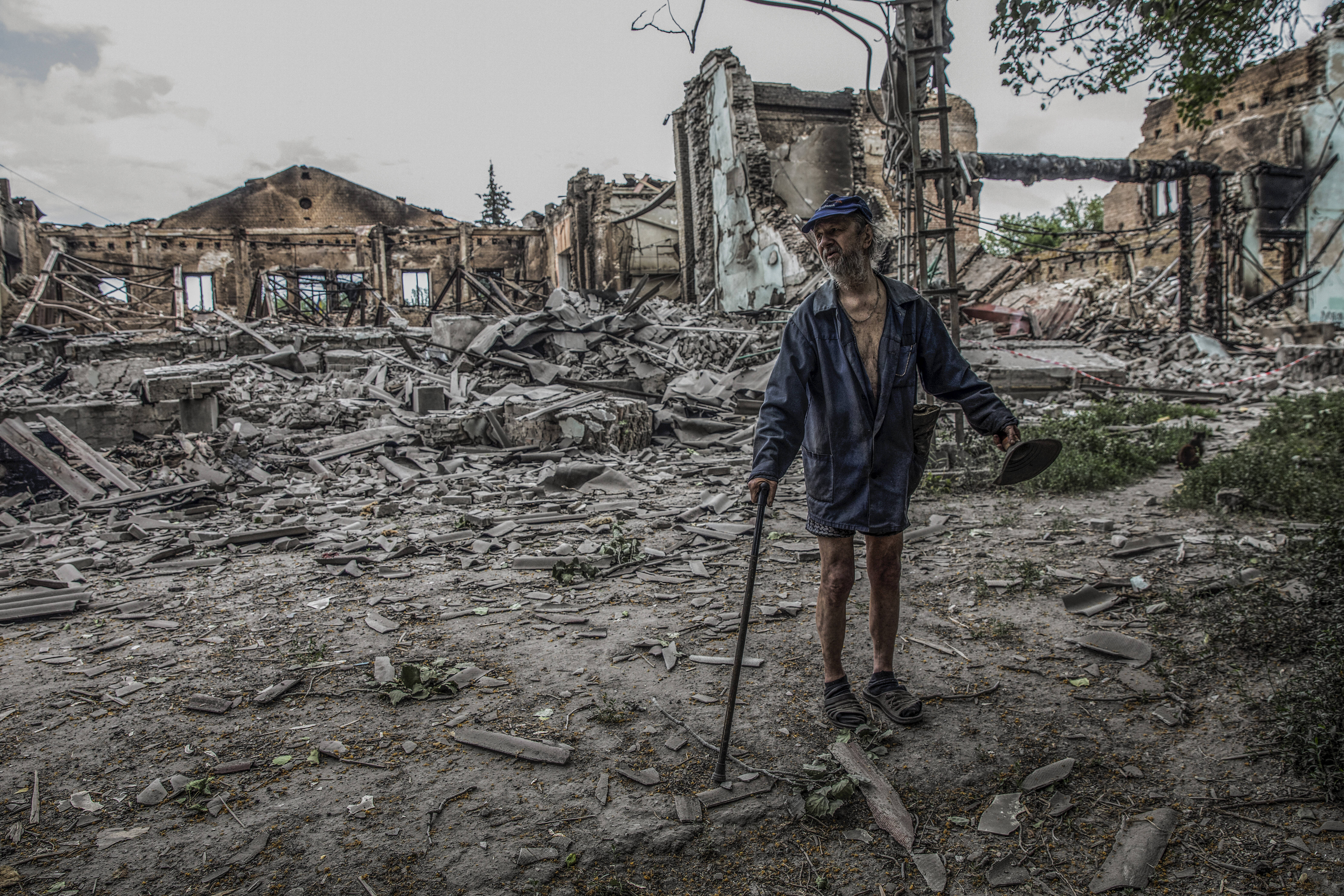 Volodia Deinega, 73, walks through the rubble of the Cultural Center in Lysychansk, Ukraine, on June 22. (Heidi Levine/FTWP)