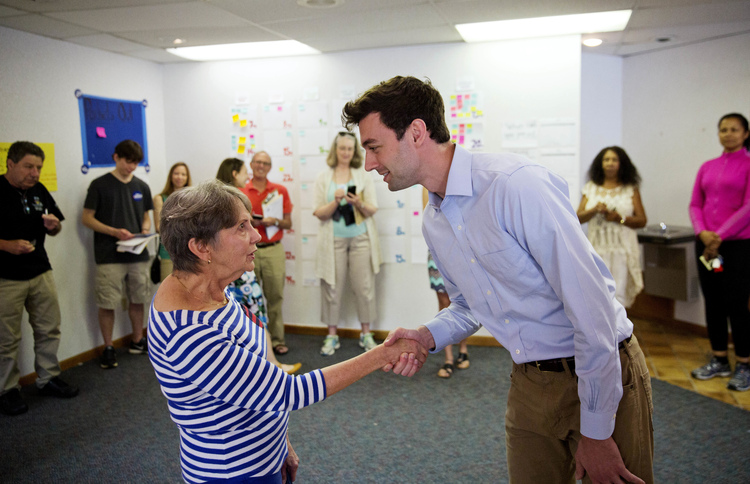 Volunteer Harriet Zoller, left, greets Jon Ossoff in May.&nbsp;(David Goldman/AP)</p>  