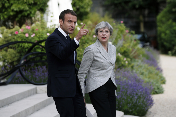Emmanuel Macron and Theresa May arrive for a joint press conference&nbsp;in Paris on&nbsp;June 13.&nbsp;(Thibault Camus/AP)</p>  