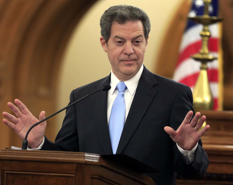 Sam Brownback speaks to the Kansas legislature in Topeka. (Orlin Wagner/AP)</p>  