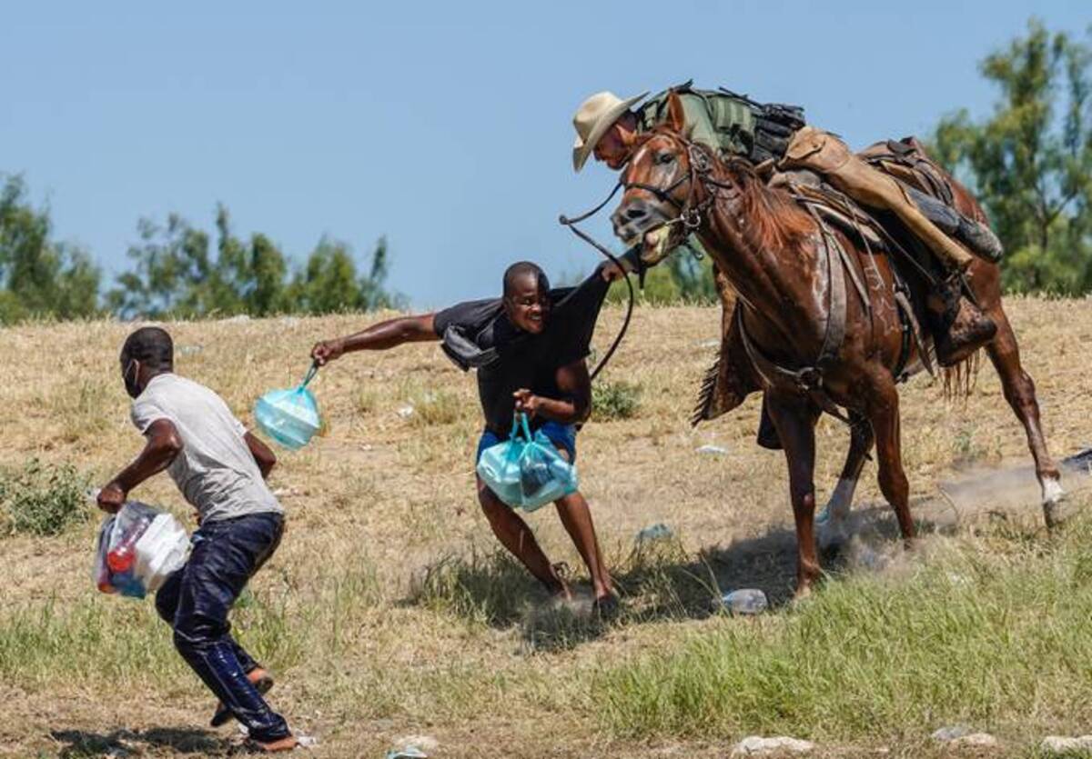 When a picture is worth a 1,000 words: U.S. Border Patrol agent on horseback tries to stop a Haitian migrant from entering an encampment on the banks of the Rio Grande. (Paul Ratje/AFP)&nbsp;