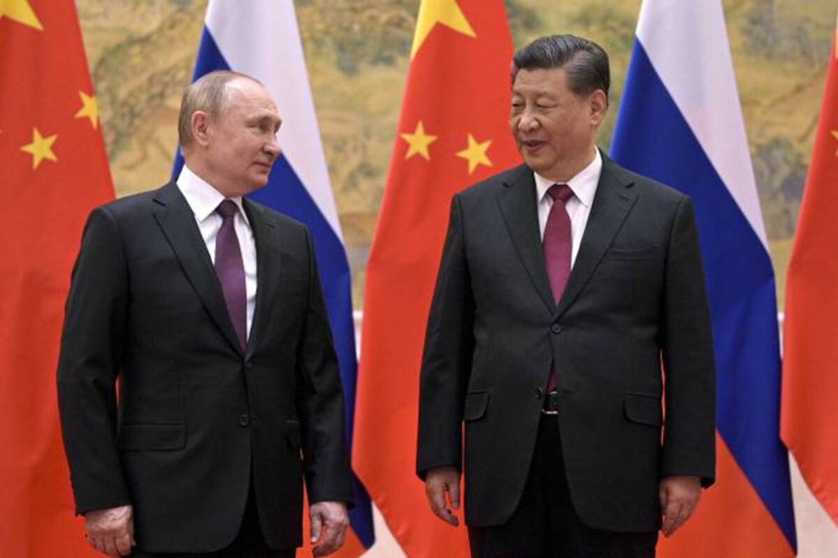 Chinese President Xi Jinping, right, and Russian President Vladimir Putin talk to each other during their meeting in Beijing on Feb. 4. (Alexei Druzhinin, Sputnik, Kremlin Pool Photo via AP)