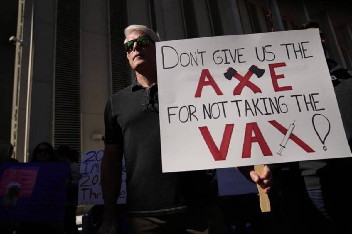 A man holds a sign as several hundred anti-mandate demonstrators rally outside the Capitol during a special legislative session considering bills targeting coronavirus vaccine mandates in Tallahassee (Rebecca Blackwell/AP)