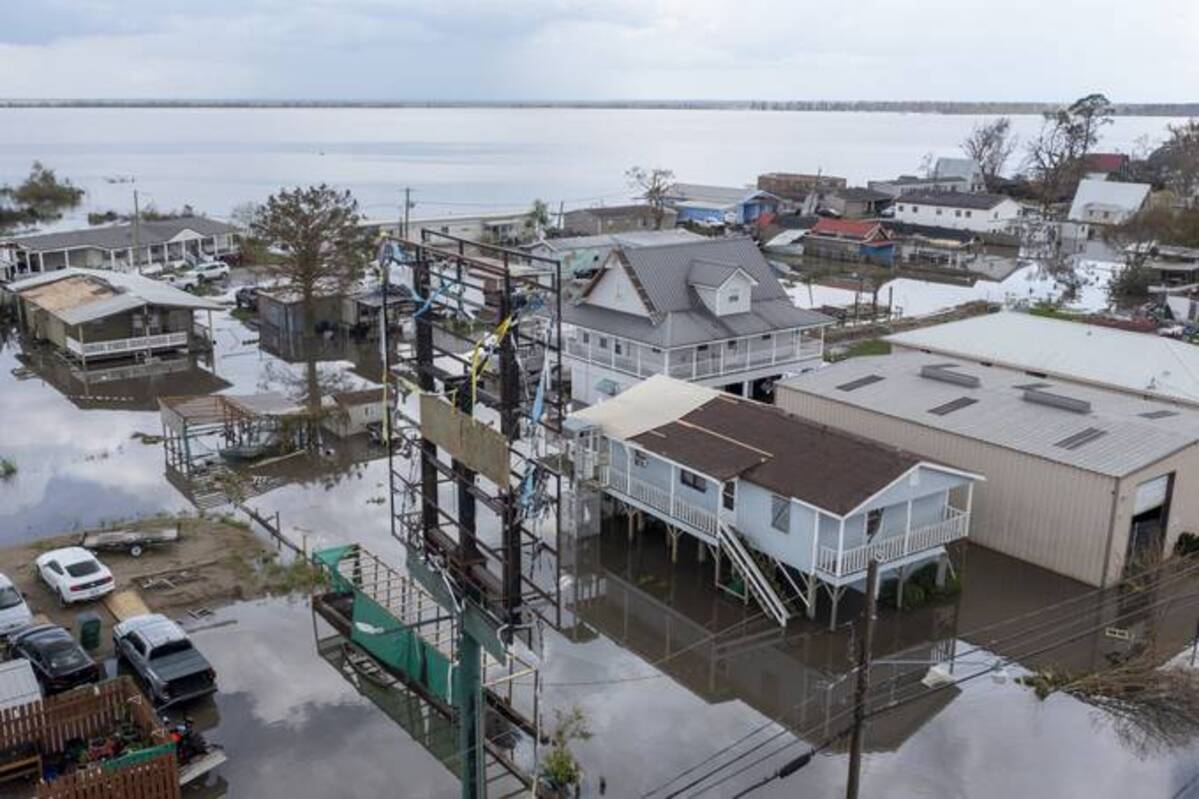 Flood waters surround storm damaged homes in Lafourche Parish, La., as residents try to recover from the effects of Hurricane Ida. (Steve Helber/AP)