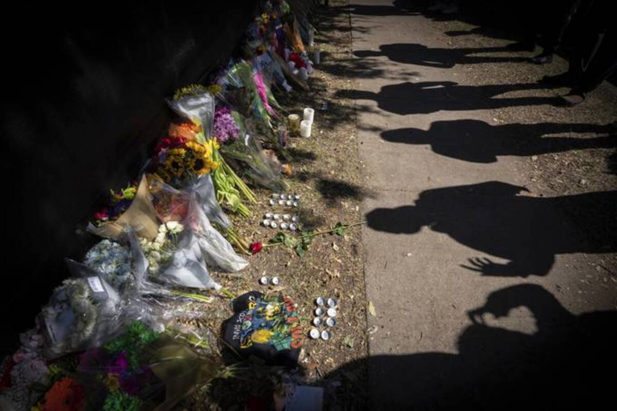 Visitors cast shadows at a memorial to the victims of the Astroworld Festival in Houston on Nov. 7. (Robert Bumsted/AP)