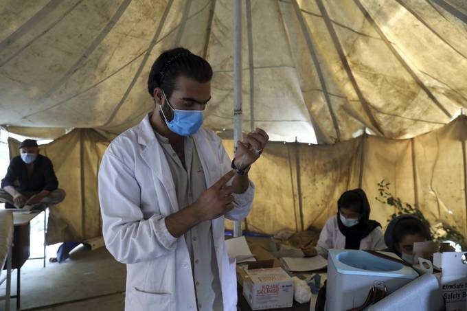 A doctor fills a syringe with the Johnson &amp; Johnson vaccine donated through the U.N.-backed Covax program at a vaccination center in Kabul on July 11. (Rahmat Gul/AP)