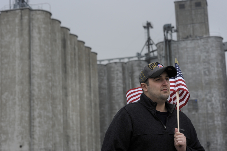 Shane Bouvet stands before a set of grain silos in his hometown. (Photo by David Zalaznik for The Washington Post)</p>  