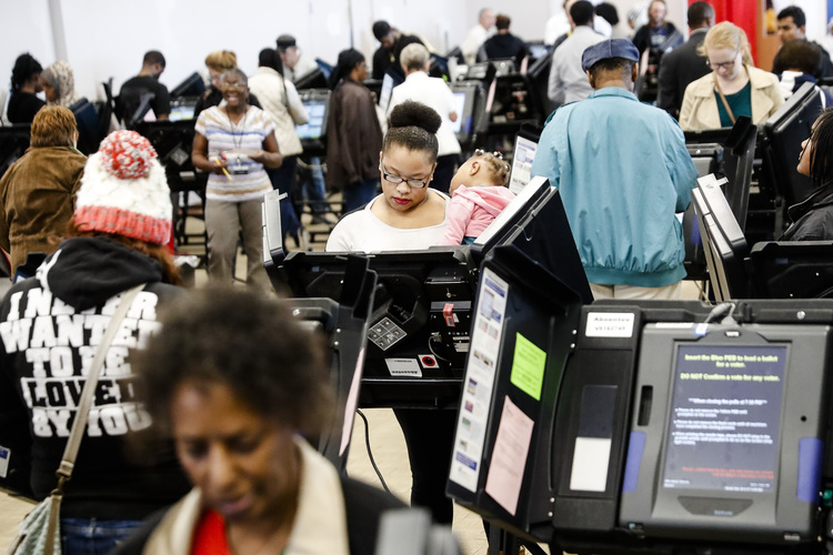 Voters cast ballots yesterday in Columbus, Ohio, at the Franklin County Board of Elections. (John Minchillo/AP)</p>  