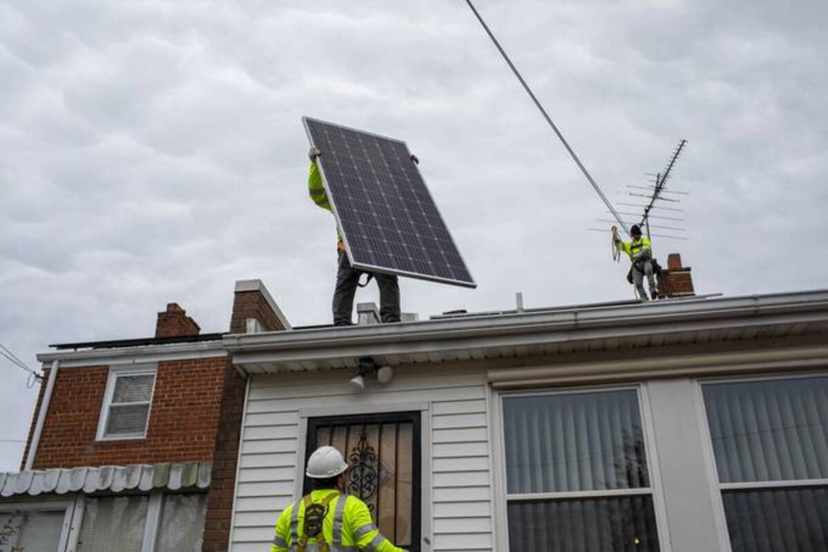 Workers install solar panels at a D.C. home on Feb. 23. (Robb Hill/The Washington Post)