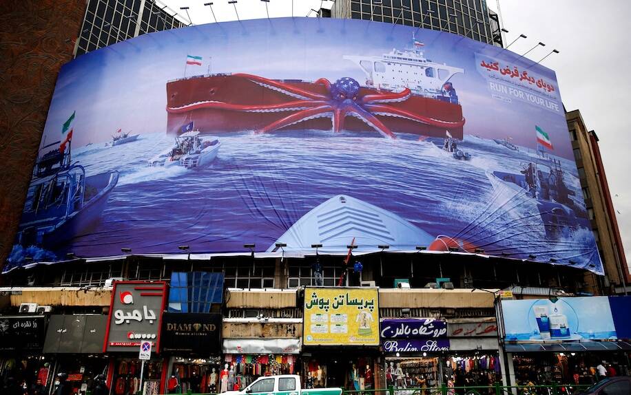 A billboard depicting Iranian Revolutionary Guards navy units rushing toward an Iranian tanker held captive by a giant octopus in the colors of the American flag in Tehran on Nov. 5, 2021. (AFP/Getty Images)