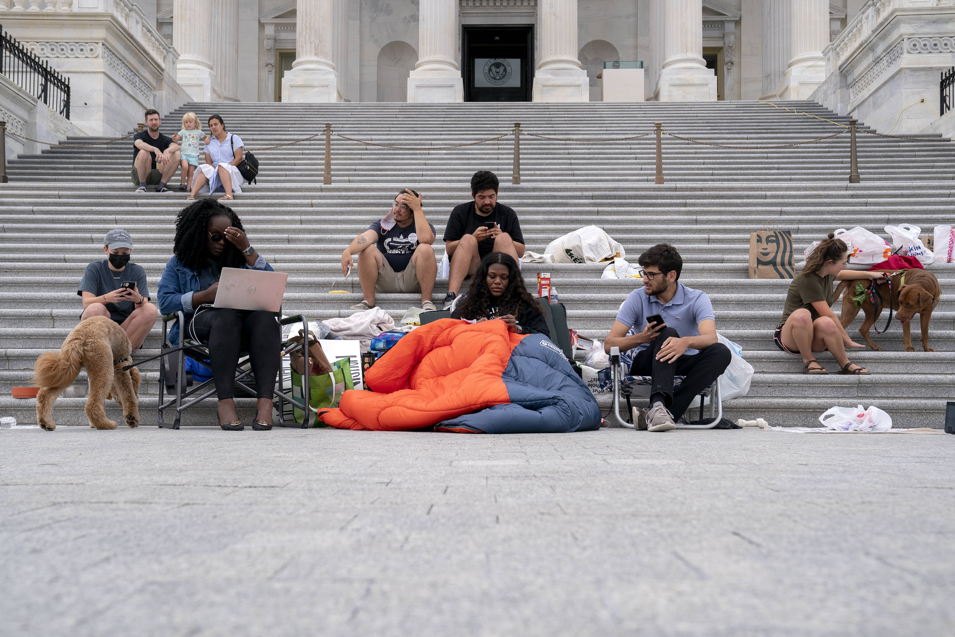 Rep. Cori Bush (D-Mo.), with congressional staffers, starts camping out on the Capitol steps on Saturday as the eviction moratorium expires. (Stefani Reynolds/Bloomberg)