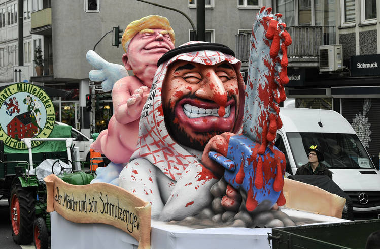 A float depicts President Trump as an angel behind Saudi Crown Prince Mohammed bin Salman with a bloody chain saw prior to the traditional carnival parade in Düsseldorf, Germany, last month. (Martin Meissner/AP)  