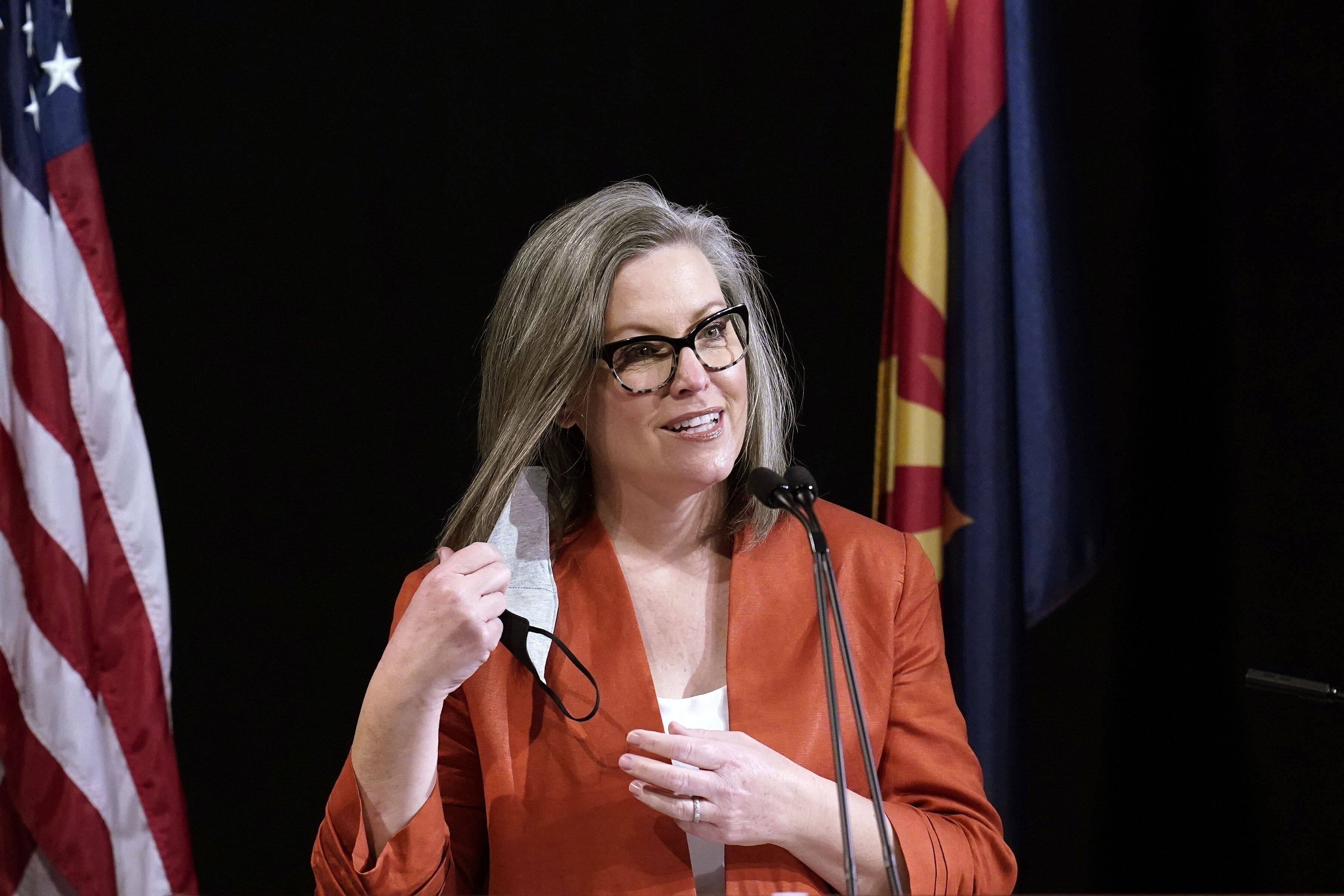 Arizona Secretary of State Katie Hobbs removes her face mask as she addresses the members of Arizona's Electoral College prior to them casting their votes, on Dec. 14, 2020, in Phoenix. (Ross D. Franklin/AP)
