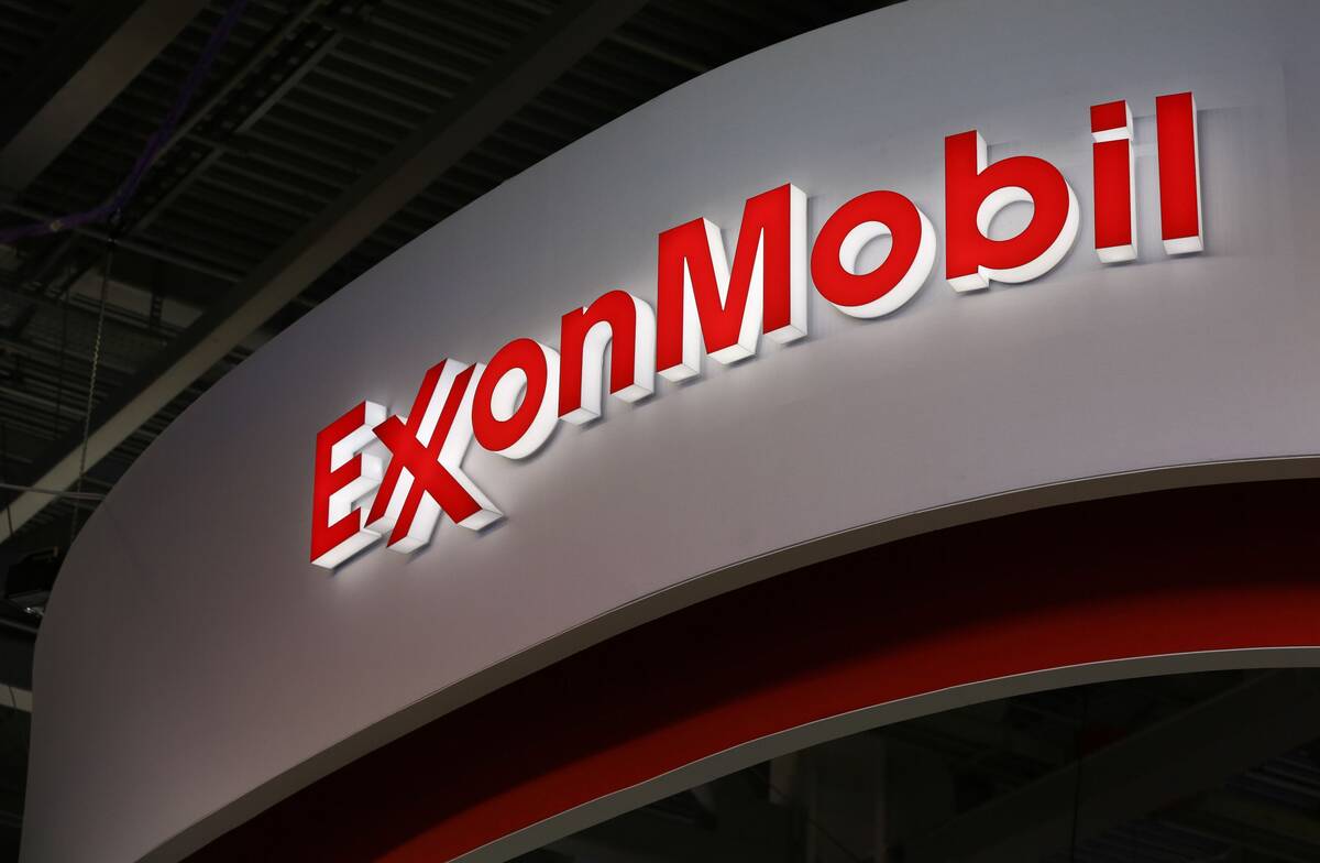 A logo sits illuminated outside the Exxon Mobil Corp. corporate pavilion during the 21st World Petroleum Congress in Moscow, Russia, on June 16, 2014. (Andrey Rudakov/Bloomberg)