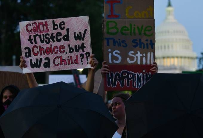 Abortion rights activists march at night in Washington, D.C., on June 24. (Astrid Riecken/The Washington Post)