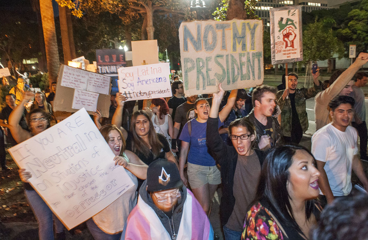 Trump protesters walk through downtown Santa Ana, Calif. (Ana Venegas/&nbsp;AP)</p>  