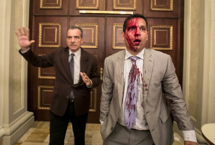 Venezuelan lawmaker Jos&eacute; Regnault, his face bloodied, leaves the National Assembly with Deputy Luis Stefanelli after a clash Wednesday with demonstrators in Caracas, Venezuela.&nbsp;(Miguel Gutierrez/European Pressphoto Agency)&nbsp;</p>  