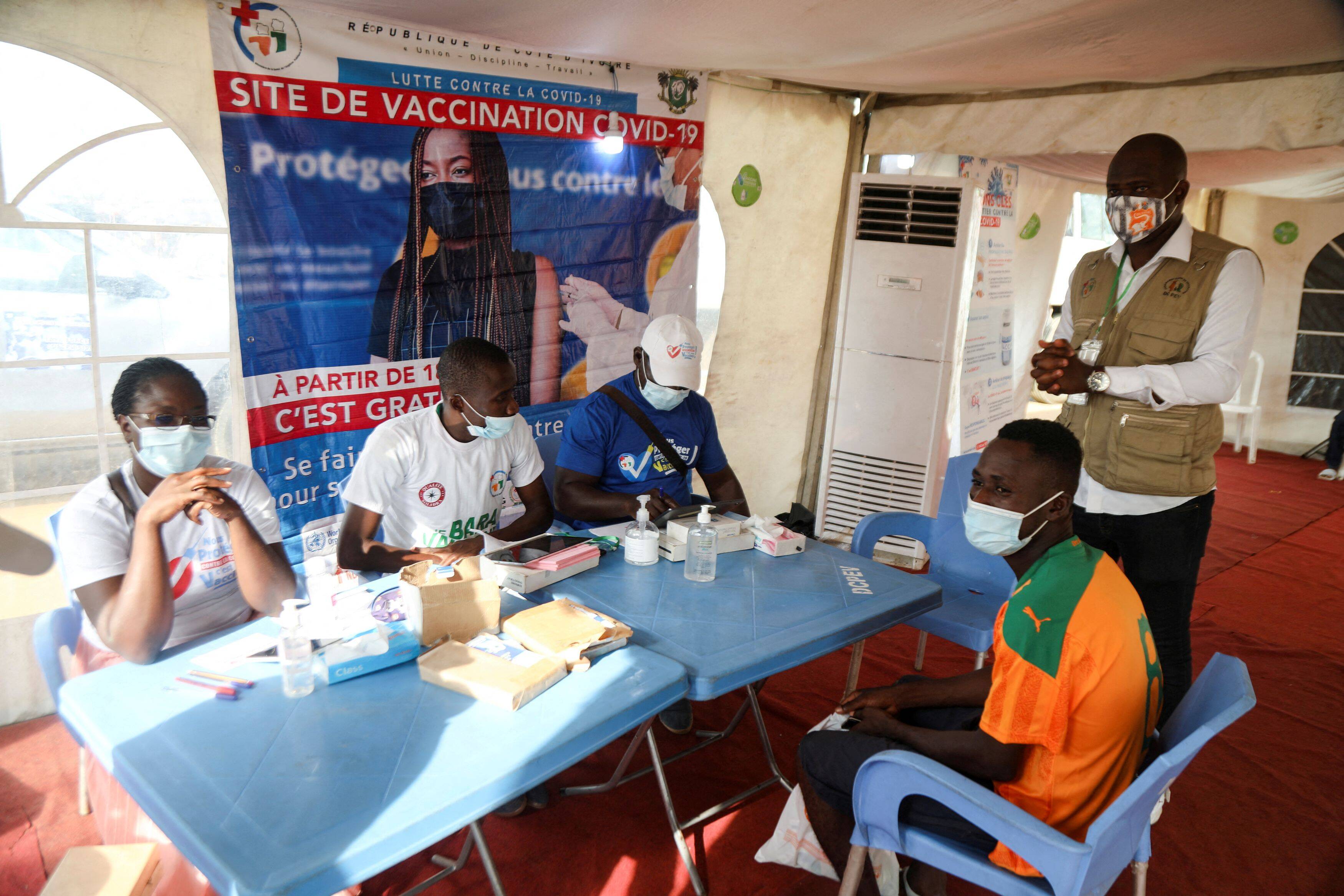 An Ivory Coast fan registers to receive the coronavirus vaccine at a vaccination center before watching an Africa Cup of Nations soccer match in Abidjan, Ivory Coast, on Jan. 12. (Luc Gnago/Reuters)