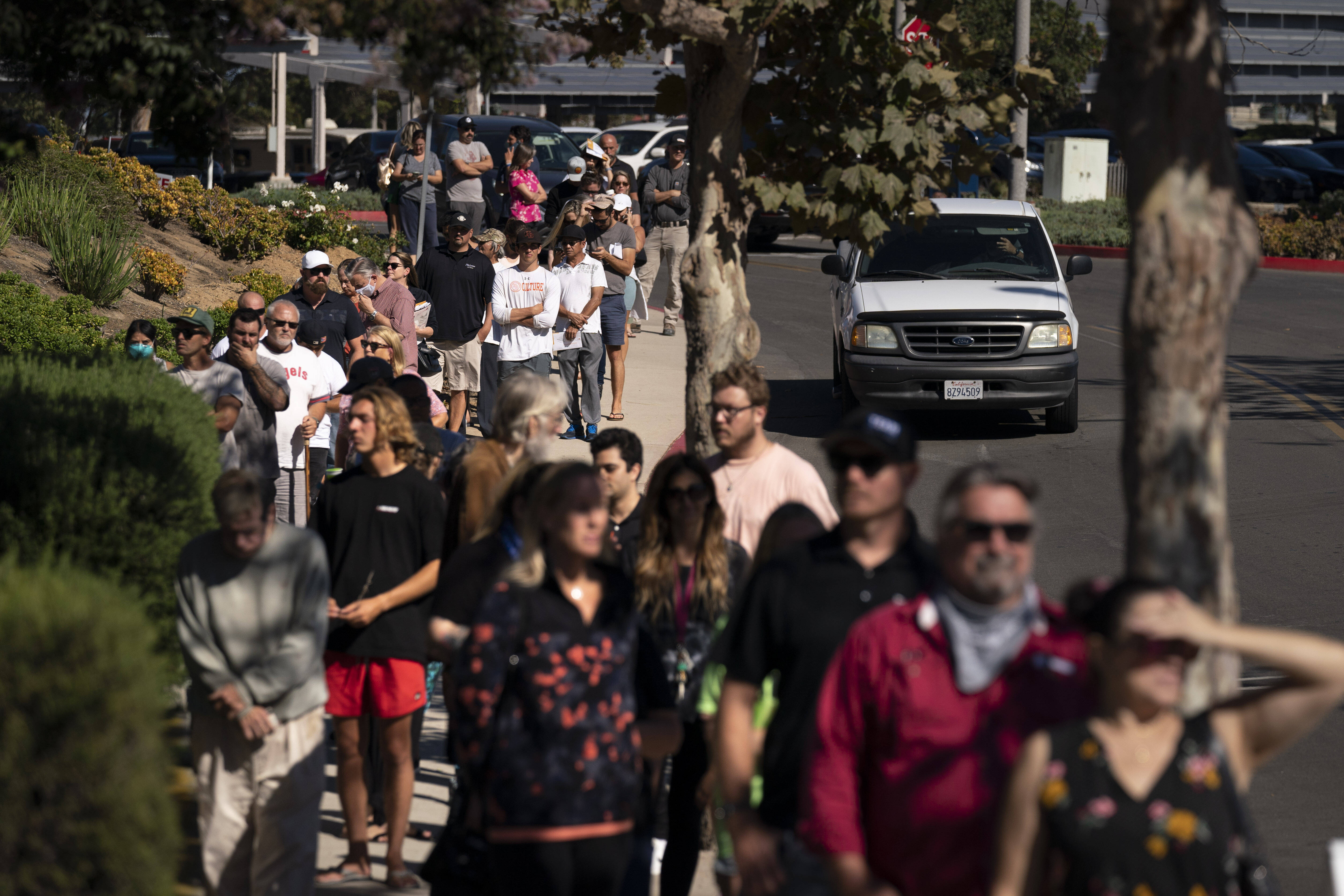 People wait in line to vote Tuesday in Huntington Beach, Calif. (AP Photo/Jae C. Hong)
