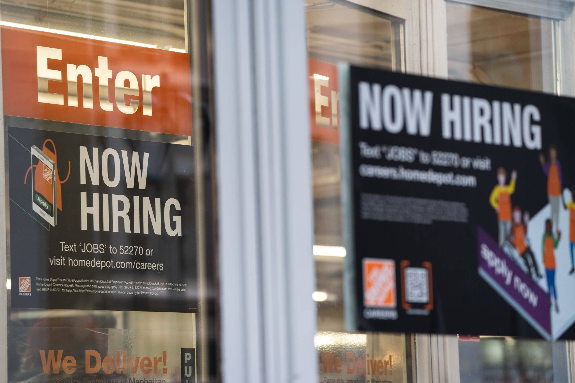 Signs at New York Home Depot in February. (Jeenah Moon/Bloomberg News)