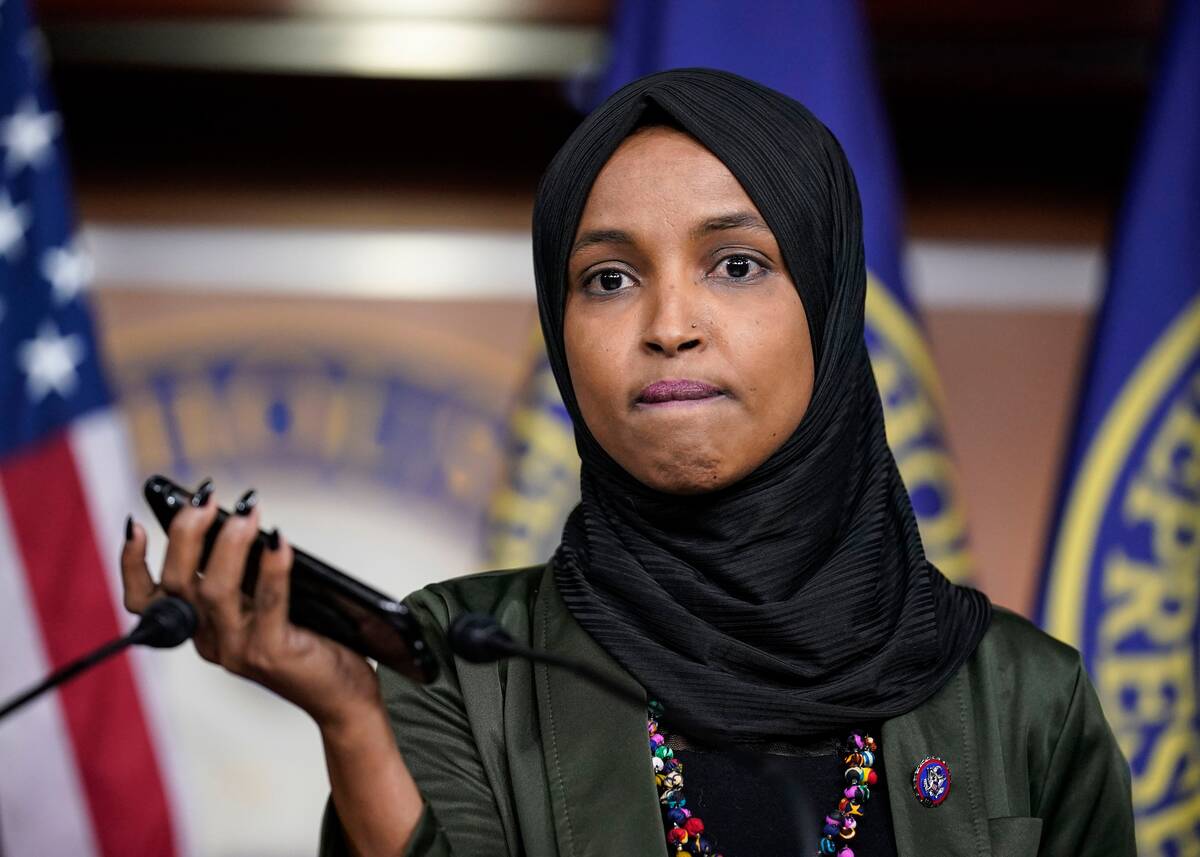 Rep. Ilhan Omar (D-Minn.) plays a recording of a death threat left on her voicemail during a news conference on Nov. 30, 2021. (J. Scott Applewhite/AP Photo)